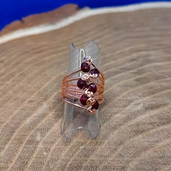 Anello intrecciato con cristalli rossi
